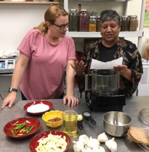 Julie Davis and Nalini Goordial cooking
