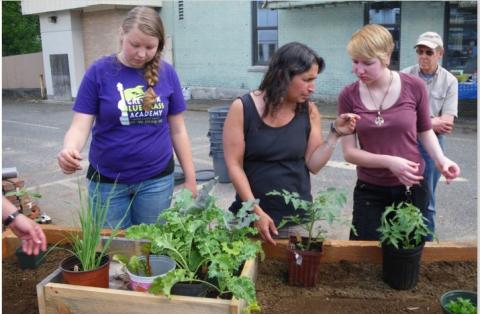 People helping to create a raised bed garden
