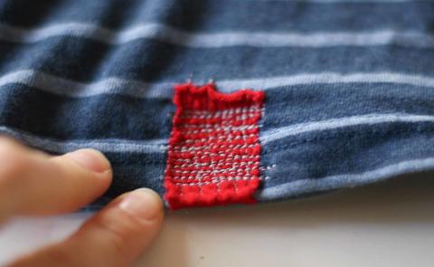 blue and white striped cloth with red patch