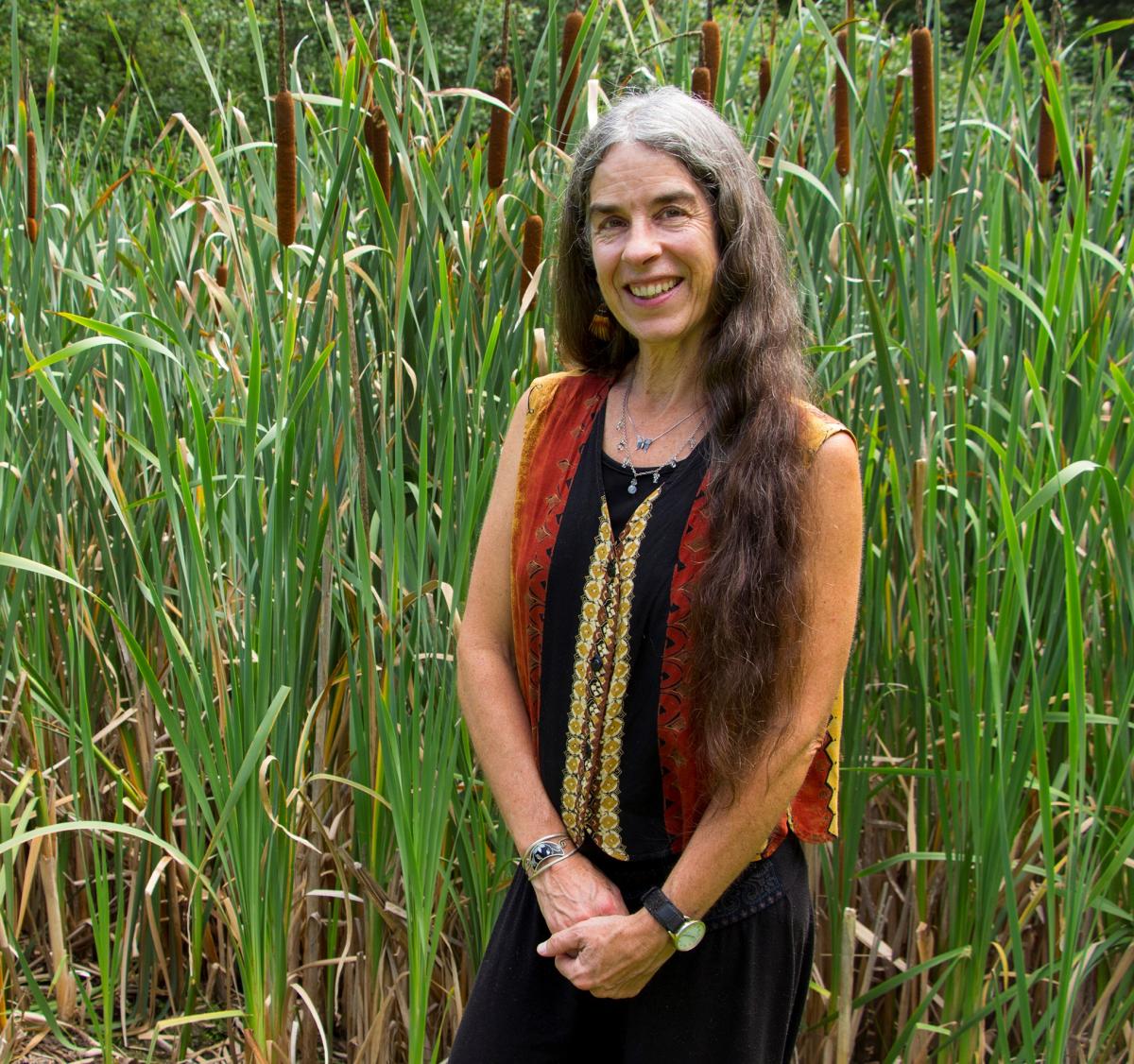 A woman standing among cattails